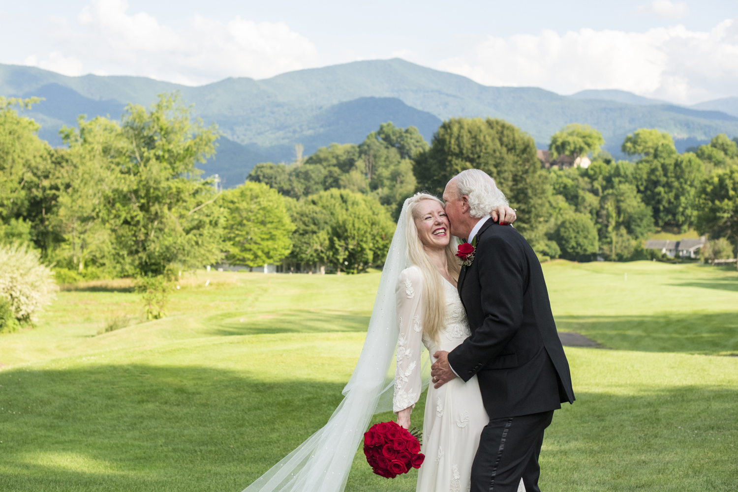 couple snuggling with mountain views during asheville elopement