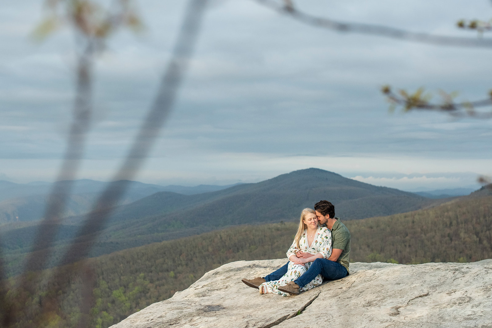 Engagement, couple snuggling at Rough Ridge near Asheville NC