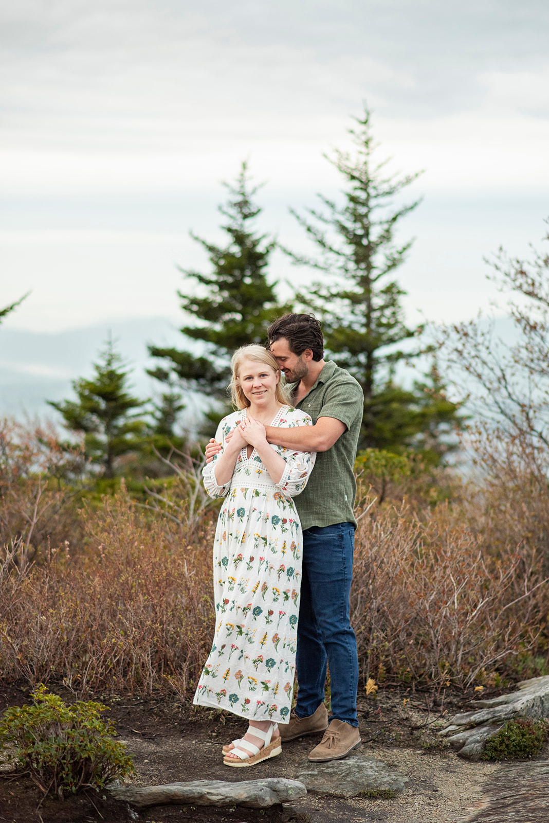 Engagement, couple snuggling at Rough Ridge near Asheville NC