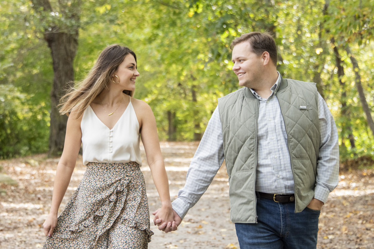 Couple walking and holding hands, captured by women owned businesses in Asheville