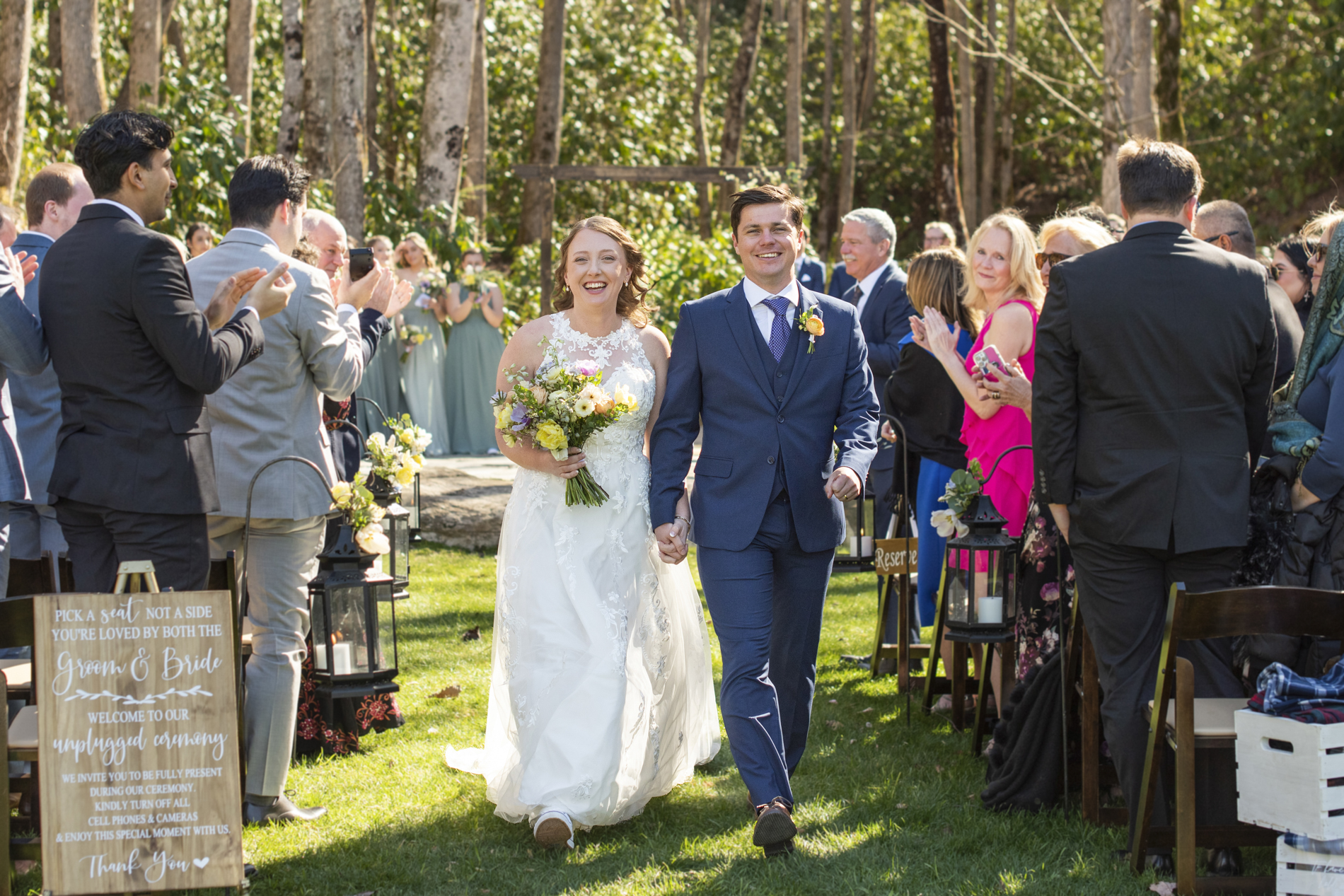 Bride and groom walking down aisle after ceremony at Hawkesdene wedding venue