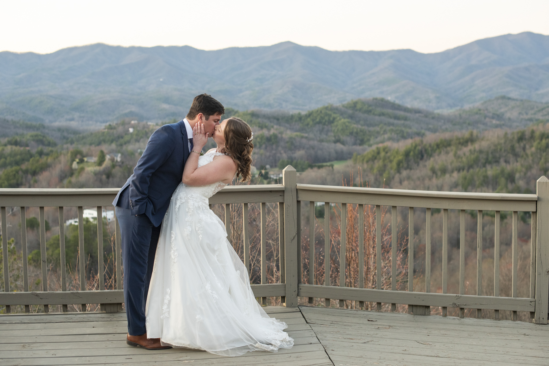 Couple kissing on mountain top at Hawkesdene wedding venue