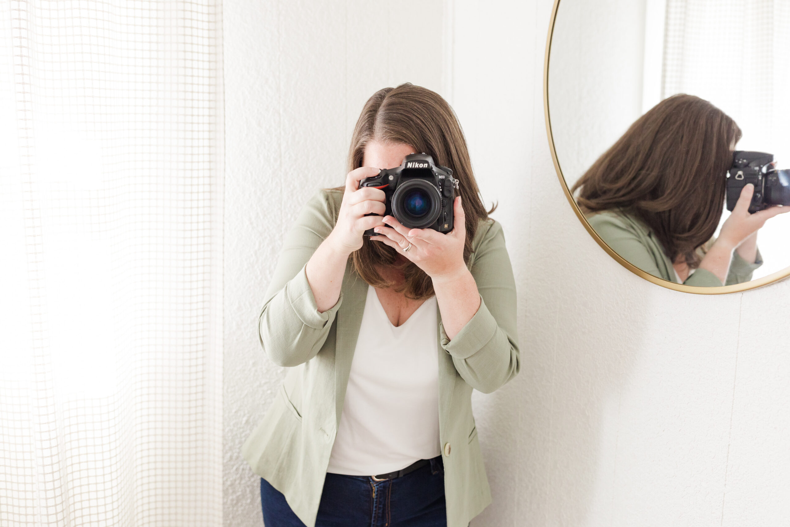 Photographer hand holding camera as women owned businesses in Asheville