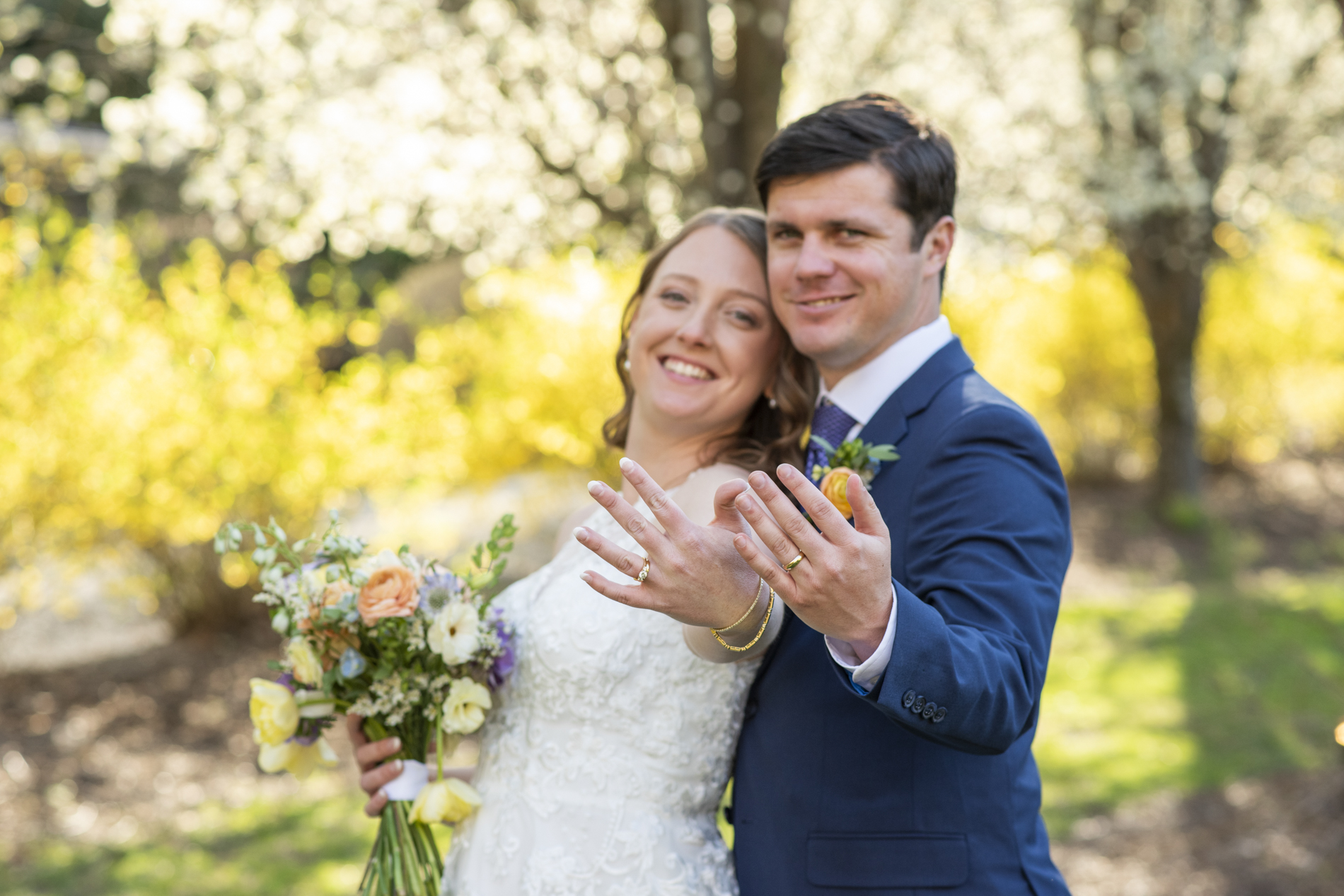 Couple showing wedding rings in Asheville