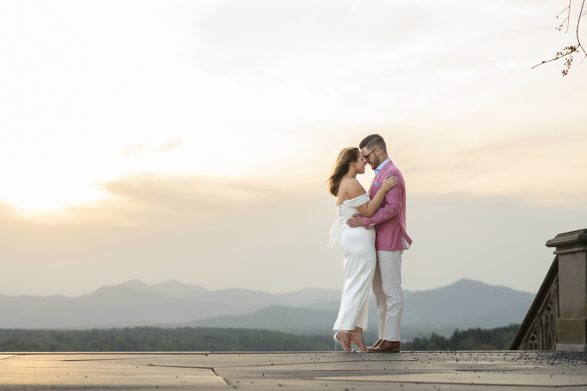 Biltmore Estate sunset with engaged couple snuggling