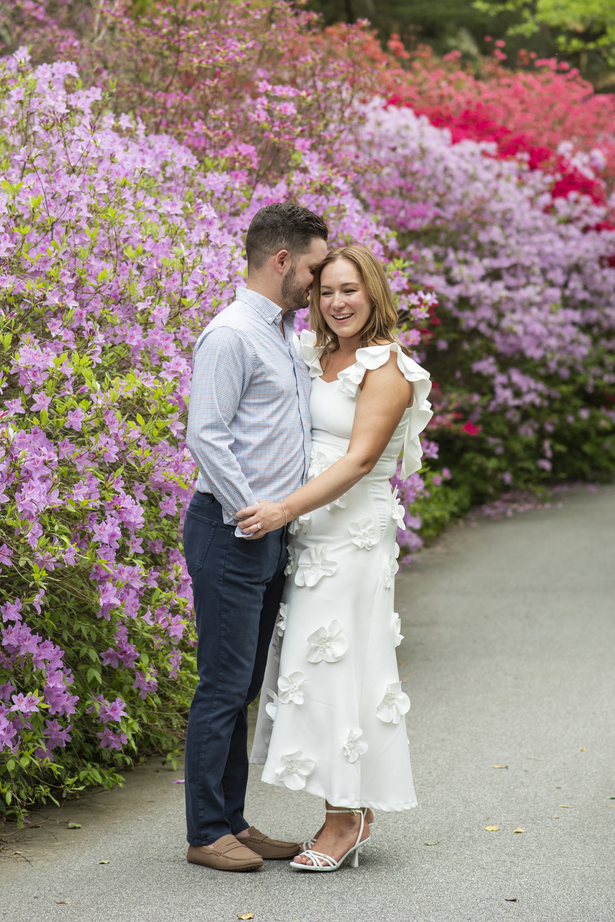Couple snuggling in Biltmore Azalea Garden in Asheville, NC