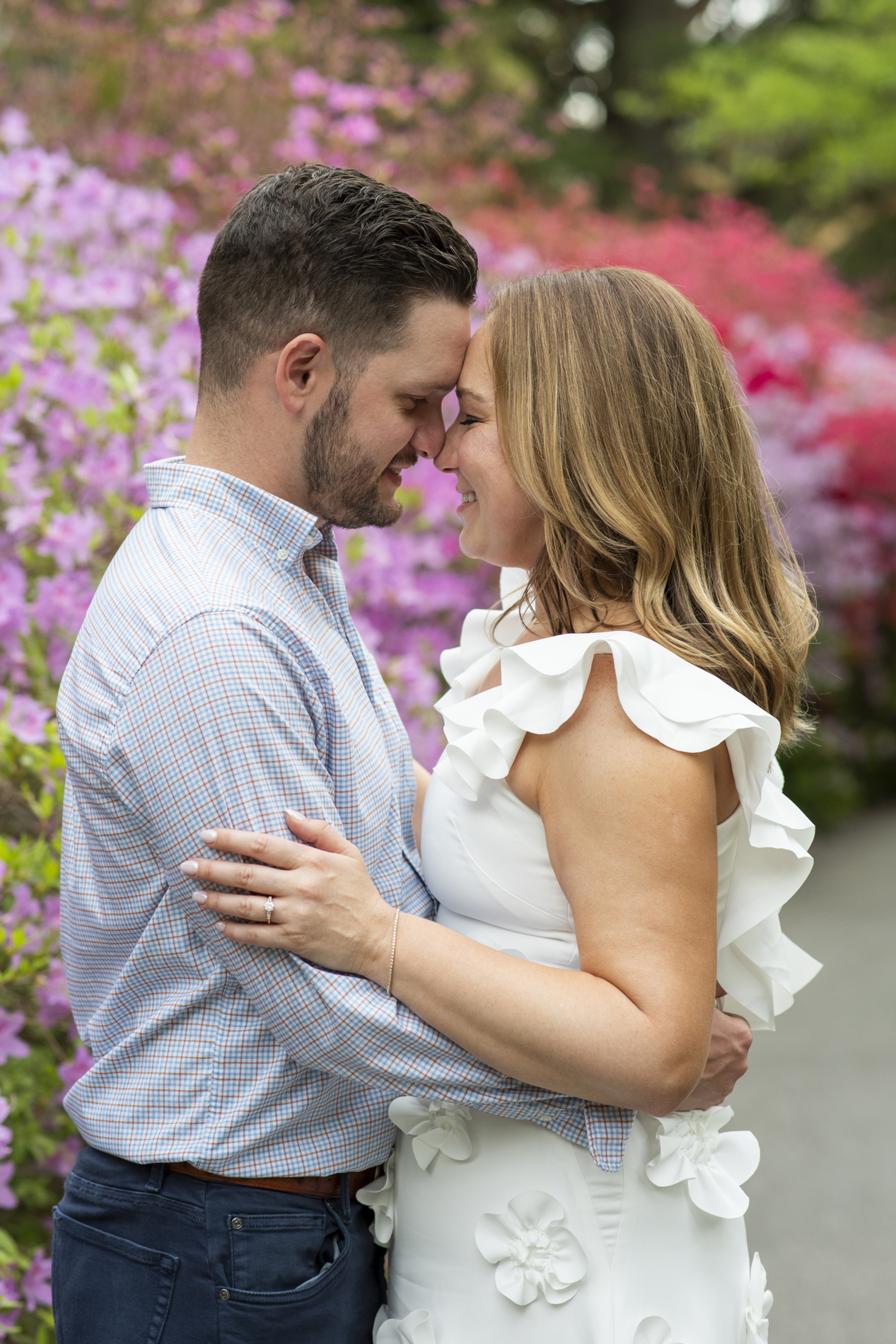 Couple snuggling in Biltmore Azalea Garden in Asheville, NC