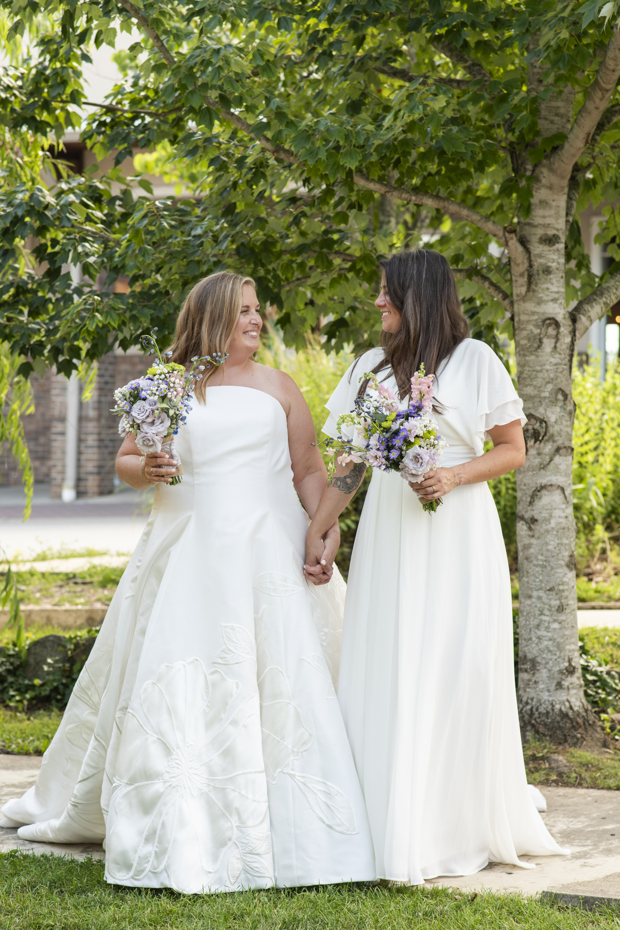 Brides walking at LGBTQ NuWray Hotel Wedding