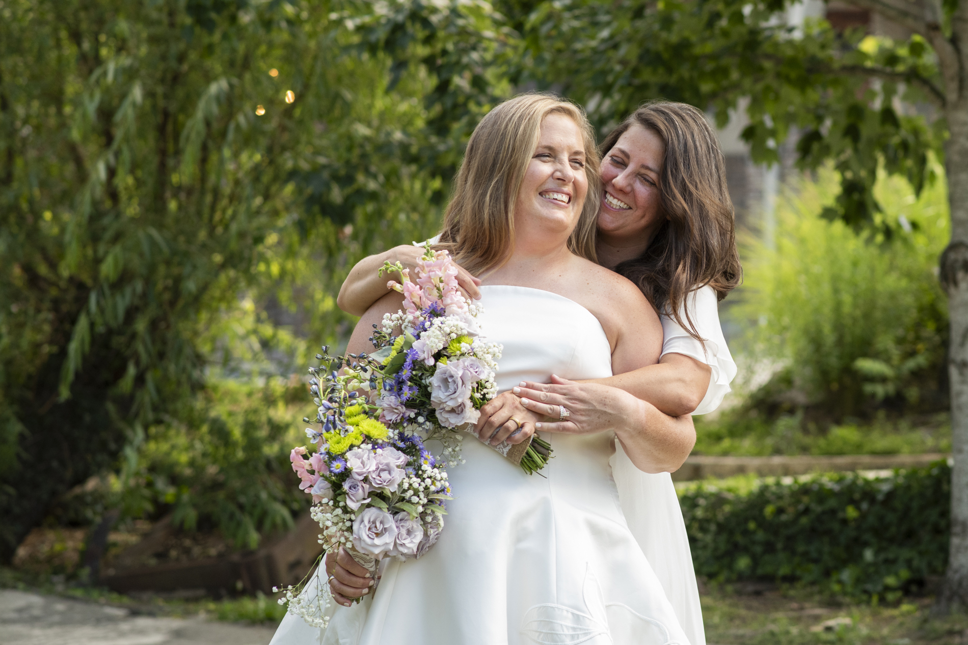 Couple snuggling at NuWray Hotel Wedding LGBTQ