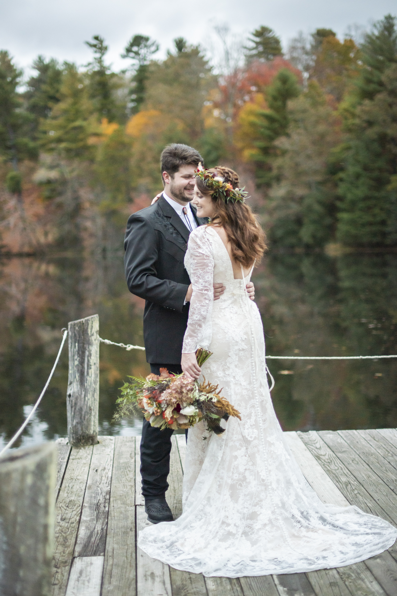 couple smiling on dock at lake at highland lake inn