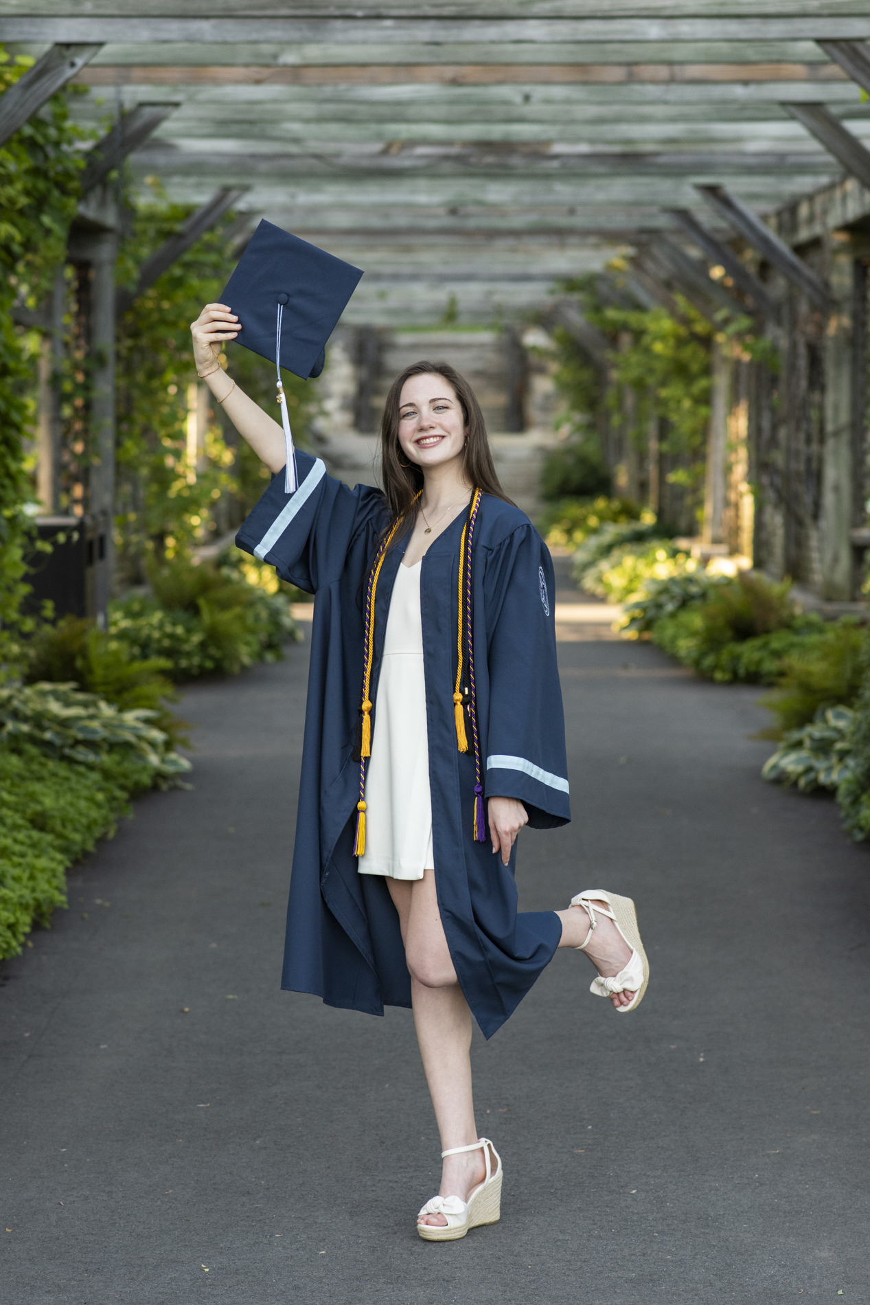 senior in cap and gown in gardens at biltmore estate