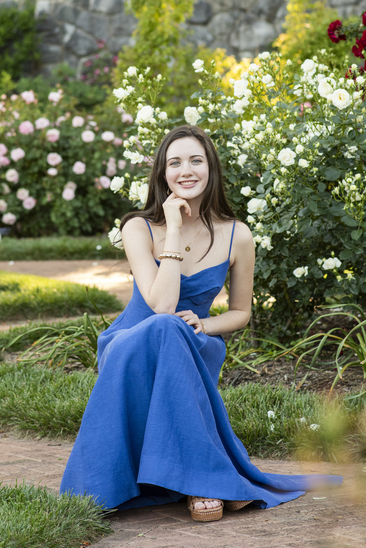 graduating senior at biltmore estate sitting in rose garden